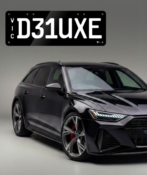 A car with a Deluxe style plate